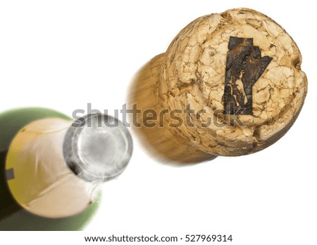 Champagne cork with the shape of Manitoba burnt in and bottle of champagne in the back.(series)