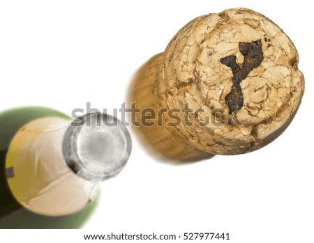 Champagne cork with the shape of Mozambique burnt in and bottle of champagne in the back.(series)