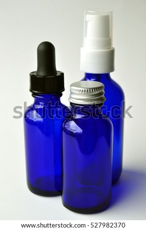 Dark blue glass bottles for cosmetic lotions, serums, oils and liquids