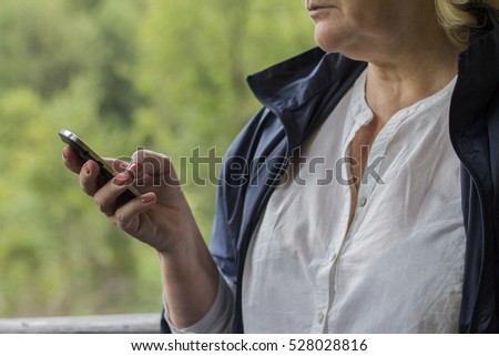 Senior woman hand holding phone