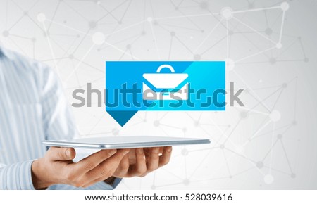 Businessman holding tablet with travel icon on screen