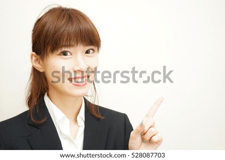 Young business woman pointing something with smile