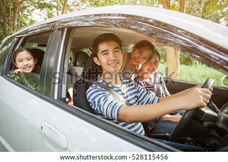 Happy Asian family on mini van are smiling and driving for travel on vacation Royalty-Free Stock Photo #528115456