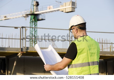 The photo shows the architect on a construction site.