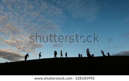 Silhouette Group of People Standing and Celebration on blue sky background