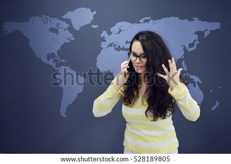 Woman talking on phone in front of background with drawn business charts.