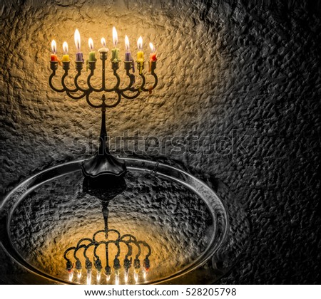 Menorah with the glitter lights of candles is the symbol of Hanukkah Jewish holiday. Image toned for inspiration of retro style and solemn evening ceremony
. 