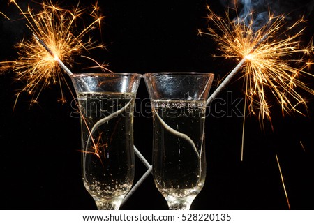Celebration theme with splashing champagne, isolated on black background.
