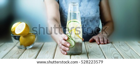 Detox. healthy eating, drinks, diet, detox and people concept - close up of woman with fruit water in glass bottle