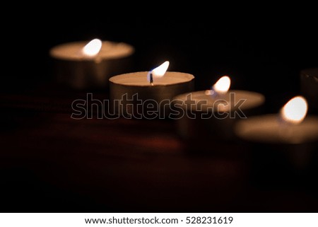 candlelight on the table in the darkness