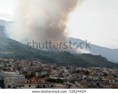 Picture present forest fire over the city in Croatia
