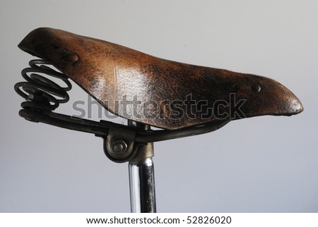 vintage leather bike saddle with metal spring Royalty-Free Stock Photo #52826020