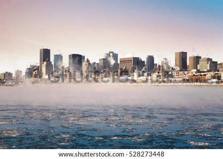 Steam rising from the frozen St Lawrence river at sunrise, with the Downtown district of Old montreal in the background. 