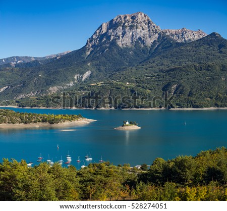 View of the Grand Morgon peak (Pic de Morgon) on Summer afternoon. The Saint Michel Bay (with the Chapel) and Serre Poncon Lake. Hautes Alpes, Southern French Alps, France
