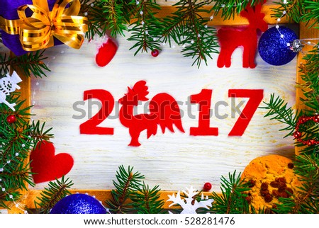 Christmas card in a frame of a Christmas tree and toys on a wooden background