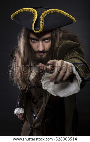 portrait of bearded and hairy pirate pointing into the viewer, shallow DOF