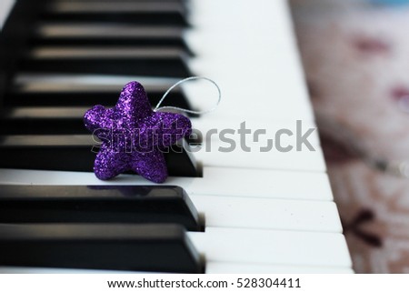 Christmas star on the keys of a piano