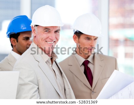 Smiling architect team working on a building project in a company