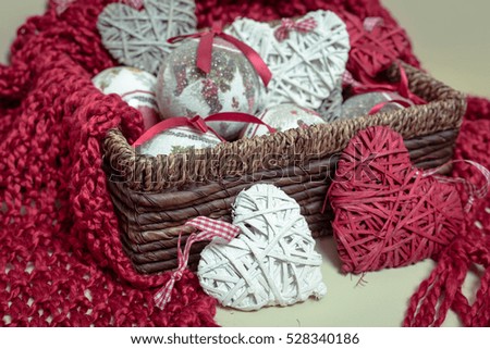 Natural Wool knitted red Scarf. Christmas Decorations in the form of balls and heart-shaped.