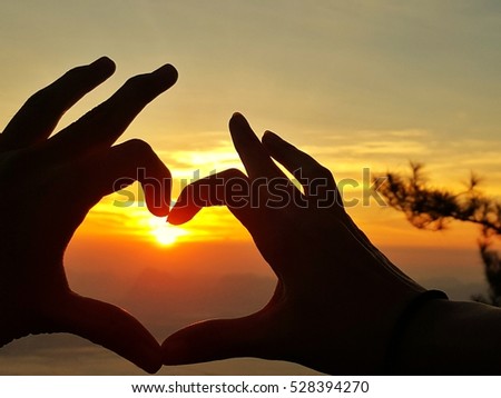 Sunrise I Love You, love symbol or heart shaped by human's hand.