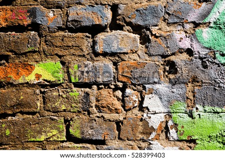damaged brick wall with remnants of paint, note shallow depth of field