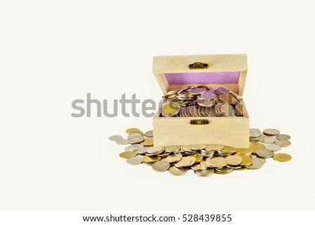 Treasure box with overflow coins all around the box on the white background