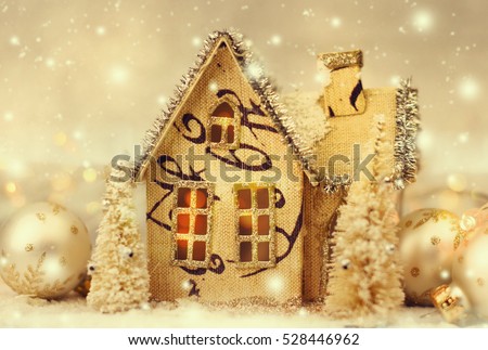 Wooden house and christmas decoration on lights background.