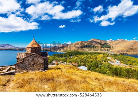 Scenic view of an old Sevanavank church in Sevan, Armenia on sunny day blue sky and fluffy clouds Royalty-Free Stock Photo #528464533