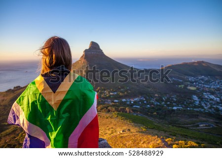 Girl holding a South African flag Royalty-Free Stock Photo #528488929