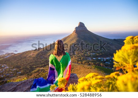 Girl holding a South African flag Royalty-Free Stock Photo #528488956