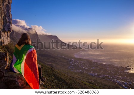 Girl holding a South African flag Royalty-Free Stock Photo #528488968