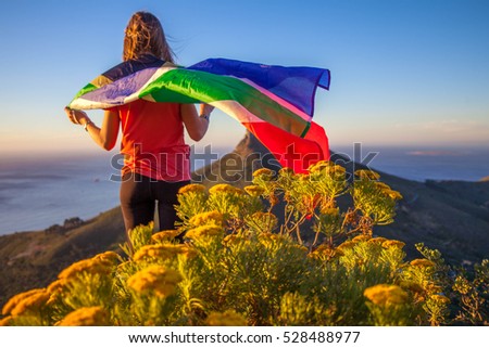 Girl holding a South African flag Royalty-Free Stock Photo #528488977