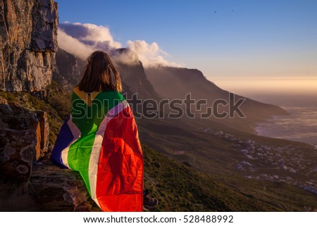 Girl holding a South African flag Royalty-Free Stock Photo #528488992