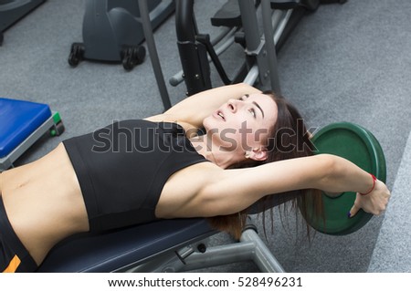 Girl is engaged in sports and gymnastics in the gym