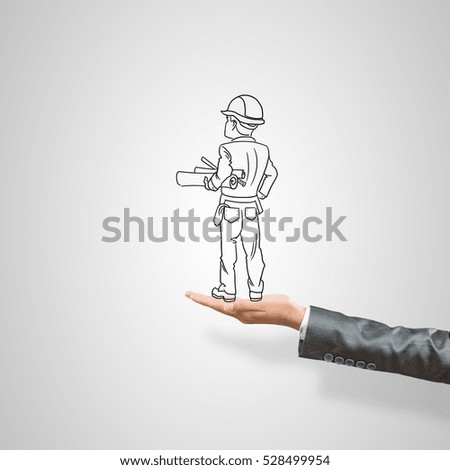 Drawn businessman in female palm on gray background
