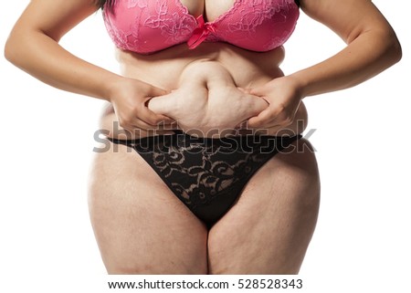 fat woman pinching her stomach on a white background