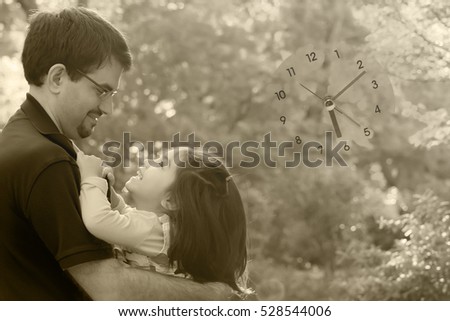  a black and white picture of little daughter laughing with happiness in daddy's arms blended with clock and autumn park background