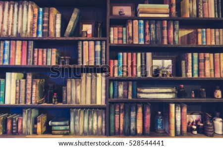 blurred Image many old books on bookshelf in library