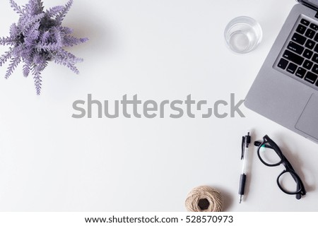 White office desk table with laptop, smartphone, pen, lavender, rope and glass. Top view with copy space, flat lay.