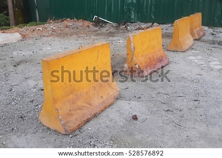 Yellow concrete road barriers at construction site