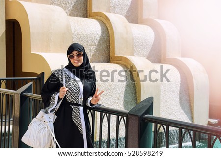 Elderly Muslim Arab Woman in Black Nikab and Abaya with a Handbag with the  Emblem of Louis Vuitton Talks on the Mobilephone Editorial Photography -  Image of abaya, talking: 271938042
