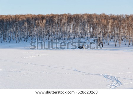 The lake in the winter under snow in Russia