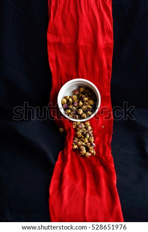 Selective focus on dry rose buds, healthy herbal tea background. Dried rosebuds, focus on the little flower. Tea dry rose. Rose buds tea cup. Selective focus. Dried rose bud used for making tea.