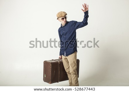 The boy in the image of a tourist with a big suitcase