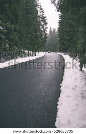 the road ahead. countryside in winter, trees and shadows - vintage retro look