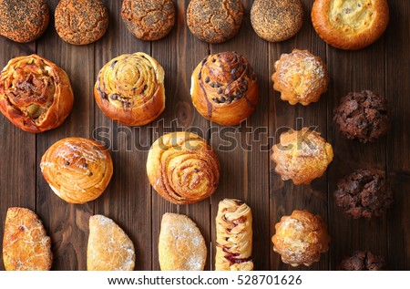 Bakery products on wooden table Royalty-Free Stock Photo #528701626