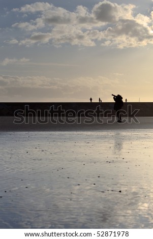 Photographer silhouette on the beach