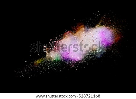 Multi-color powder explosion on black background. Mauve color cloud. Color dust explode. Freeze motion paint Holi