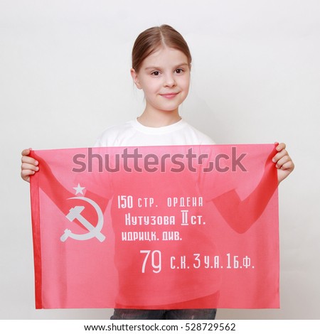Proud little girl holding Victory Banner - Assault flag of the 150th Order of Kutuzov II Degree Idritsa Infantry Division in the second World War