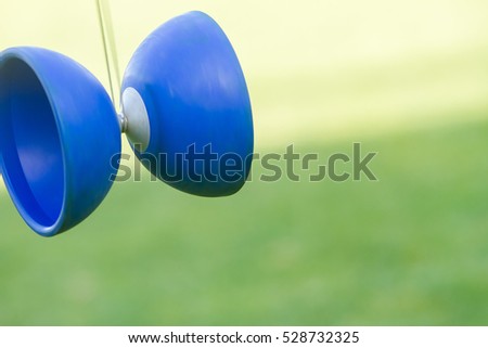 outdoor portrait of young boy playing with diabolo, chinese yo-yo toy